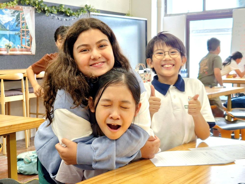 An Agora educator with laughing Student Care children