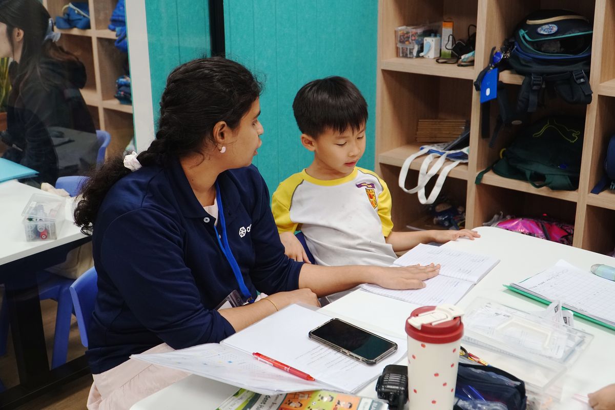 An Agora educator working one-to-one with a Student Care child