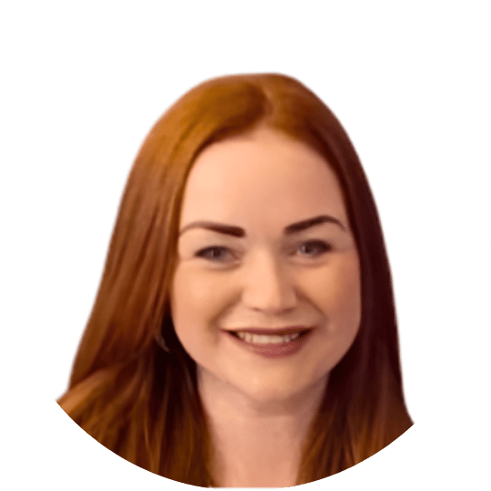Smiling woman with long red hair against a white background.