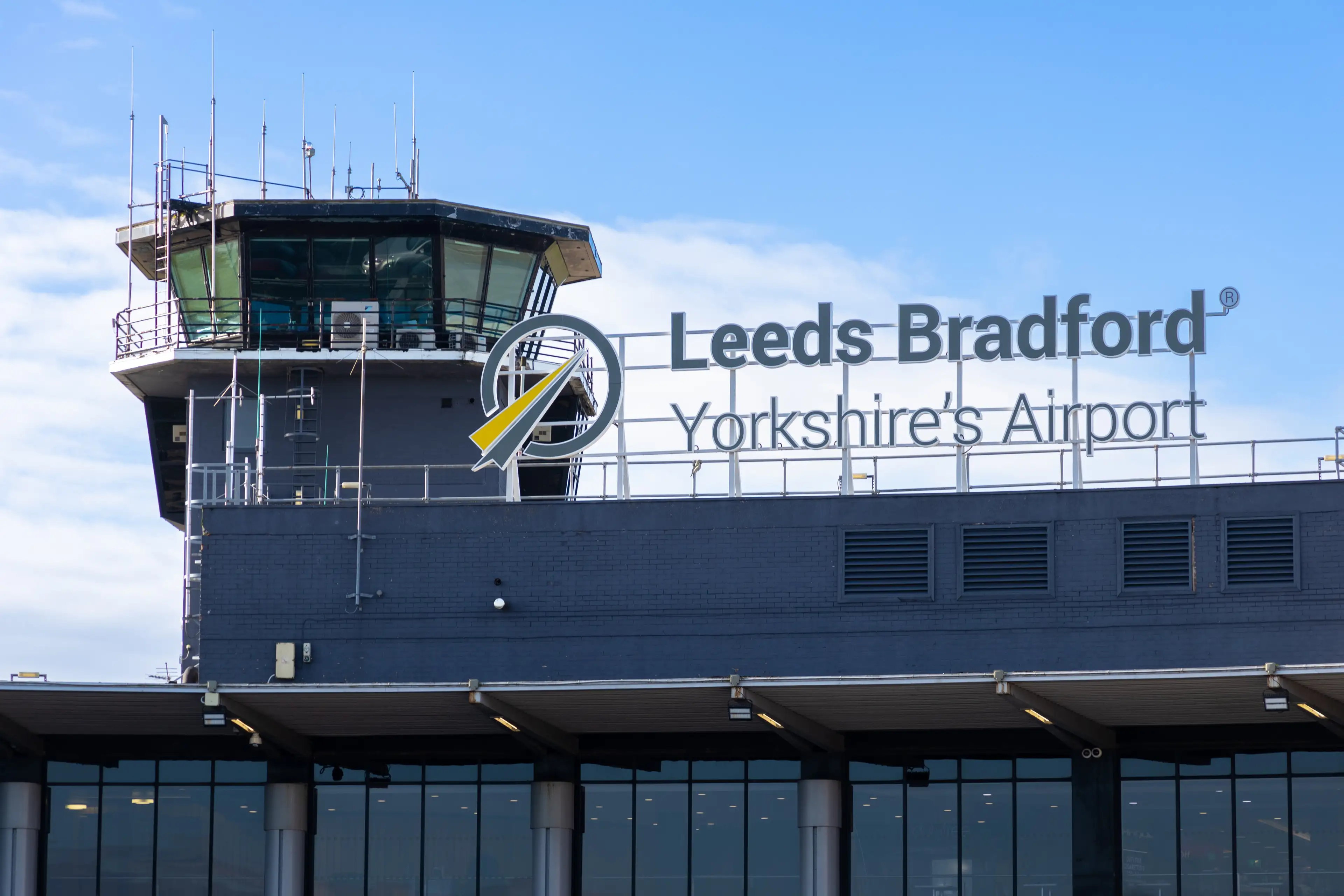 Leeds Bradford Yorkshire's Airport air traffic control tower with clear blue sky.