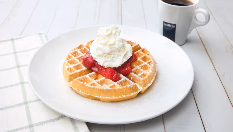 Thick, golden Belgian waffles with a light, crispy exterior and a soft, airy interior. Served with whipped butter and made to order.