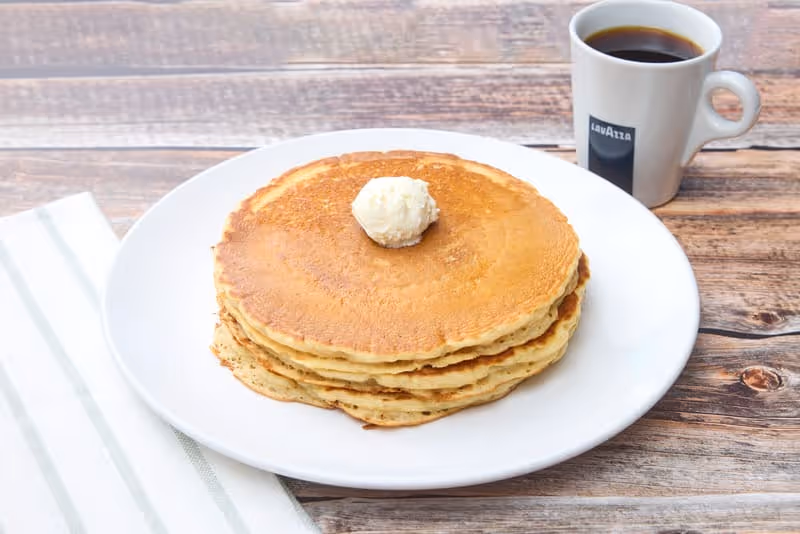 Fluffy, golden buttermilk pancakes with a light, airy texture. Served with whipped butter and made to order.