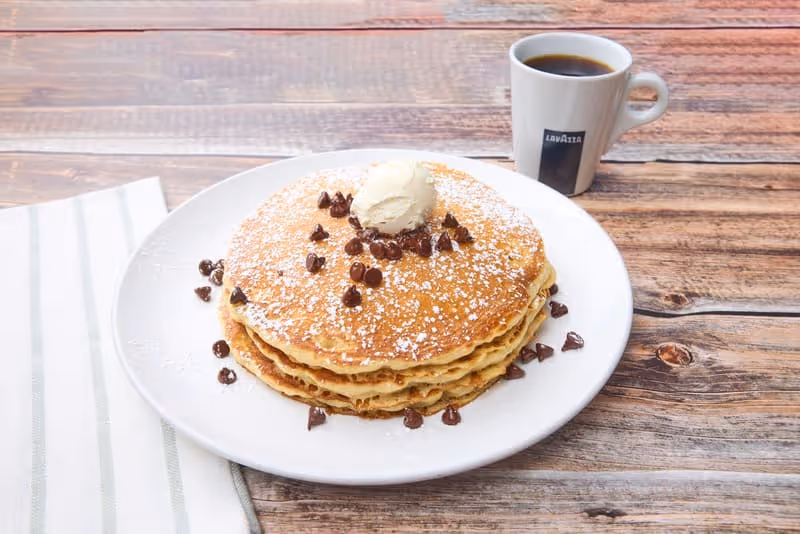 Fluffy, golden buttermilk pancakes with baked-in chocolate chips. Topped with more chocolate chips and made to order.