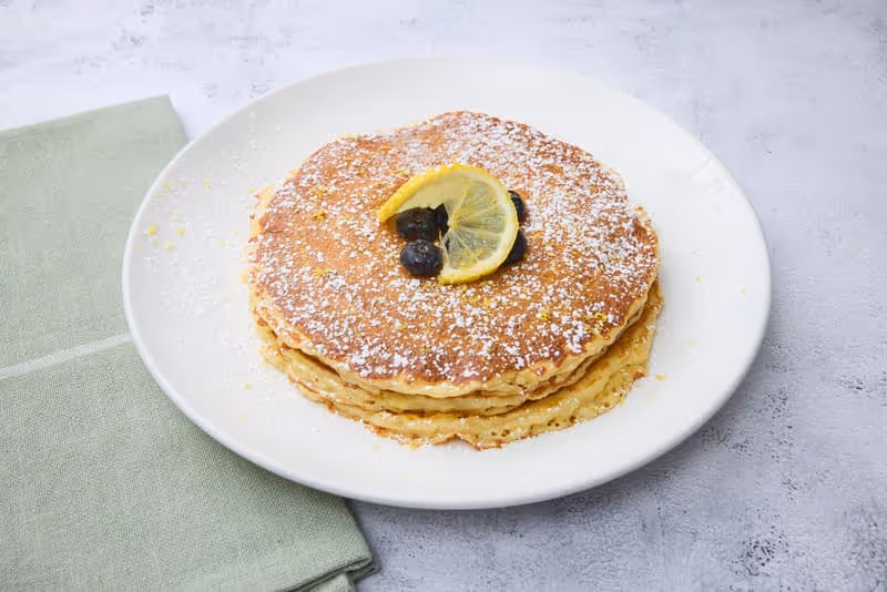 Rich and fluffy, with creamy ricotta & tangy lemon, topped with fresh blueberries, lemon zest and powdered sugar.