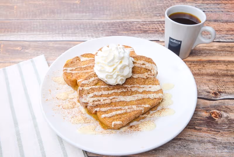 Our Classic French Toast with Cinnamon & sugar, cream cheese icing & whipped cream.