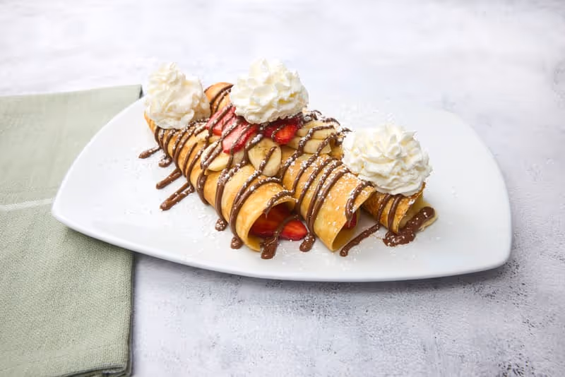 Housemade crepes with Nutella, strawberries or banana, powdered sugar and whipped cream