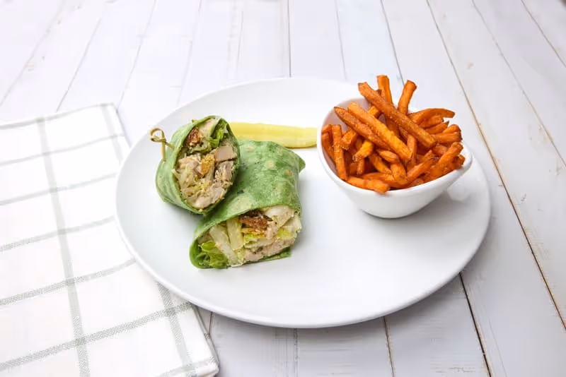 Diced grilled chicken breast, Parmesan cheese, housemade croutons and Romaine lettuce tossed with Caesar dressing and wrapped in a spinach tortilla.
