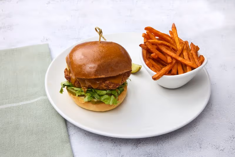 Crispy fried chicken and Carolina gold BBQ sauce with shredded lettuce, sliced pickles and mayo on a grilled brioche bun.