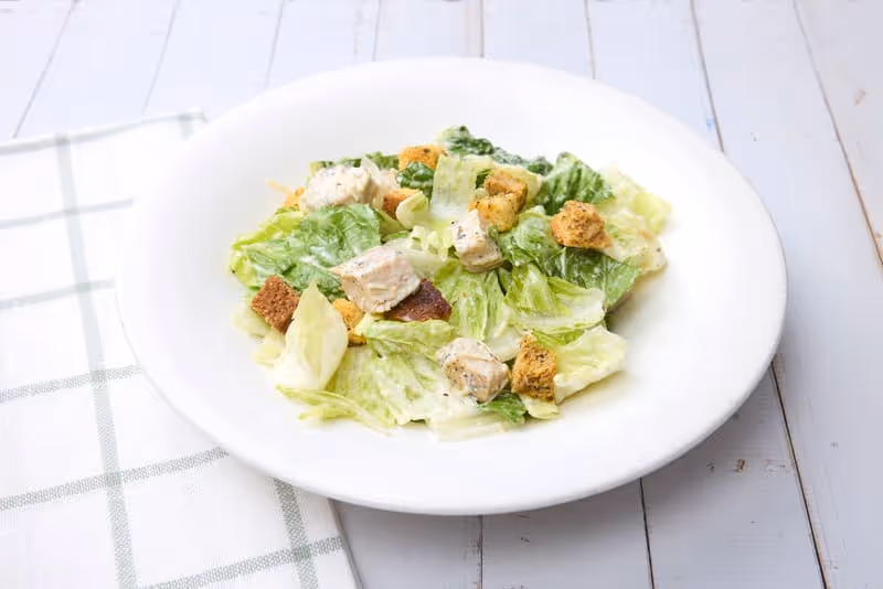 Diced grilled chicken, parmesan cheese, housemade croutons and Romaine lettuce, tossed with Caesar dressing.
