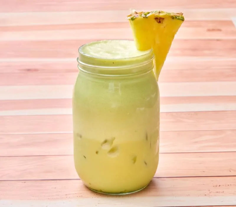 A refreshing, dairy-free beverage featuring green tea matcha shaken with pineapple juice and coconut milk.