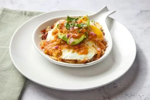 Chorizo, serrano peppers and onions sauteed with home fries. Topped with Jack cheese, sunny-side up eggs, avocado, red onion, cilantro, and ranchero sauce.