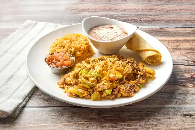 Scrambled eggs with beef barbacoa, onion, bell pepper and tomato. Served with Mexican rice, refried beans and salsa fresca.