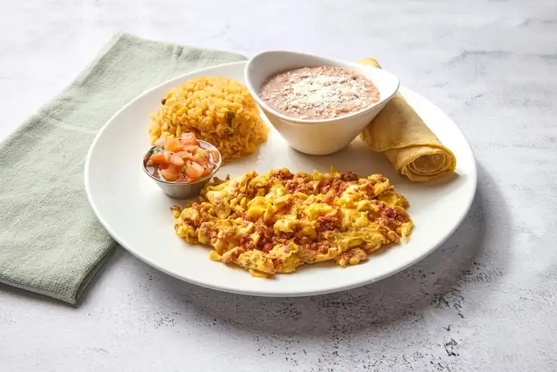 Eggs scrambled with chorizo. Served with Mexican rice, refried beans and salsa fresca.