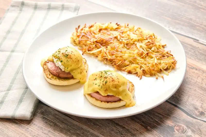 Canadian bacon, poached eggs and hollandaise on a toasted English muffin.