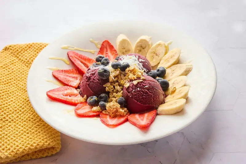 Acai berry sorbet, fresh strawberries and blueberries, bananas, shredded coconut, granola, honey.