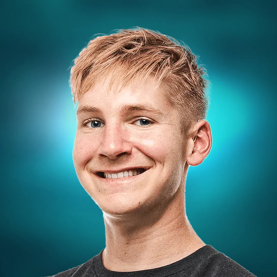 Smiling young man with short blond hair against a blue gradient background.