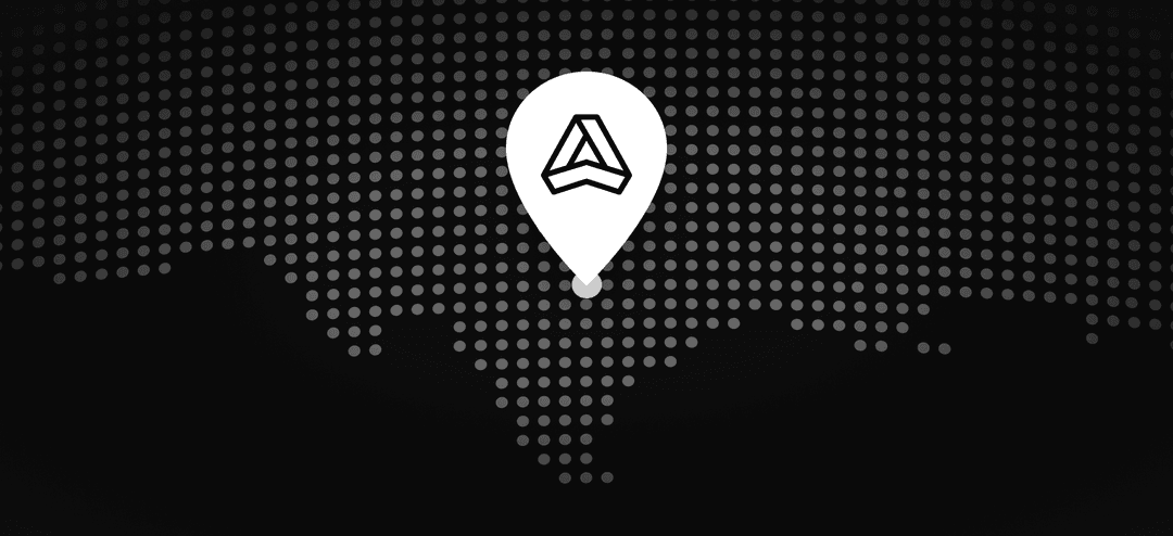 Dark dotted map with a white location pin icon containing a geometric triangular logo in the center.