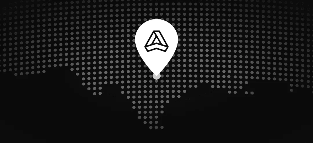 Dark dotted map with a white location pin icon containing a geometric triangular logo in the center.