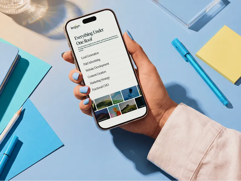 Leapyn full-service marketing agency website displayed on mobile phone showing services including lead generation, paid advertising, and content creation