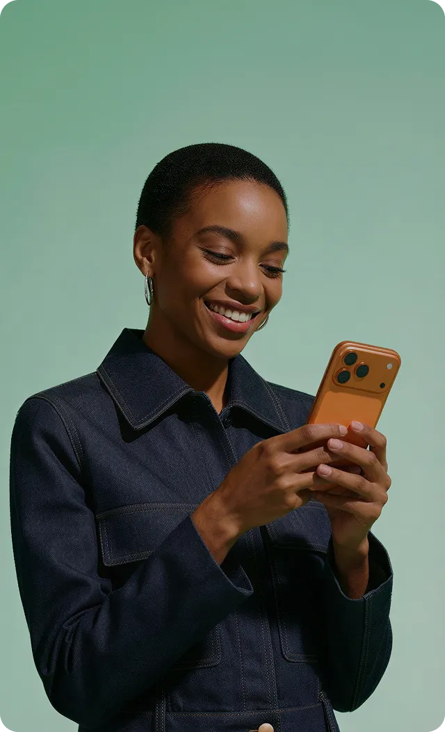 Smiling woman engaging with social media content on her smartphone
