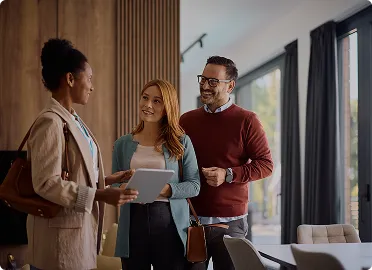 Real estate agent showing property to prospective home buyers
