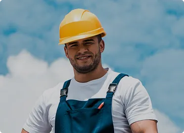 Professional roofer in hard hat performing residential roof installation