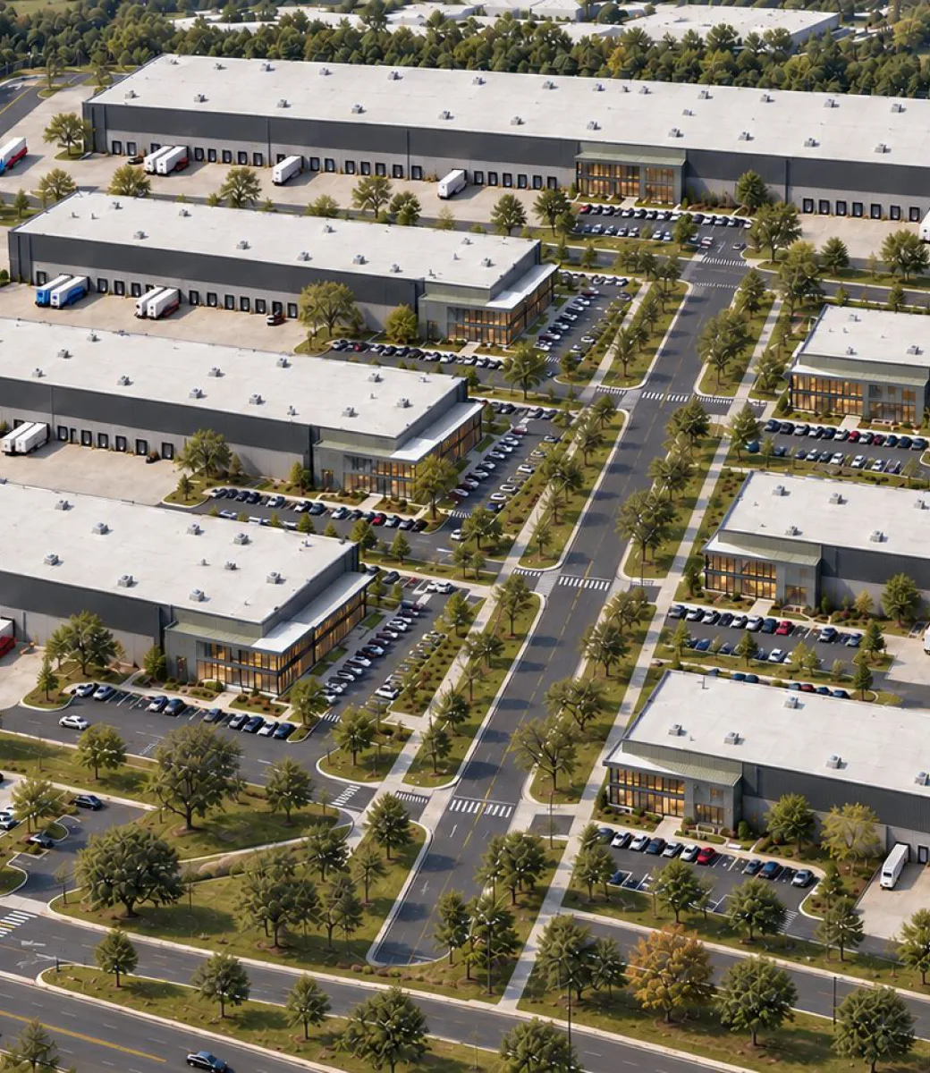 Aerial view of an industrial park with warehouses, loading docks, parking and tree lined roads