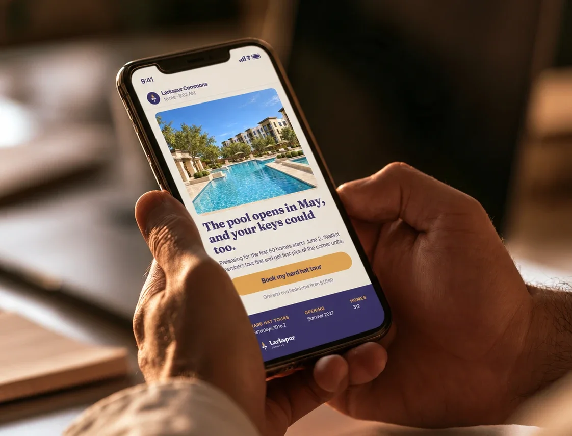 Hands holding a phone showing a Larkspur Commons waitlist email with a pool rendering and a button to book a hard hat tour
