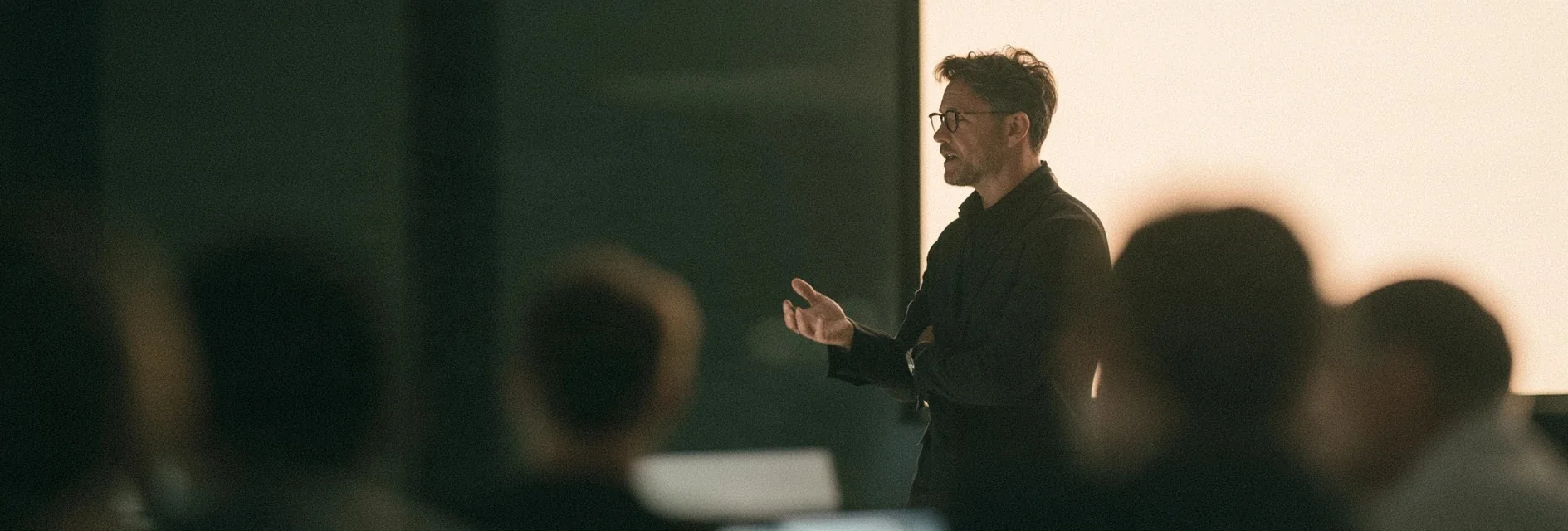Man presenting to a seated audience