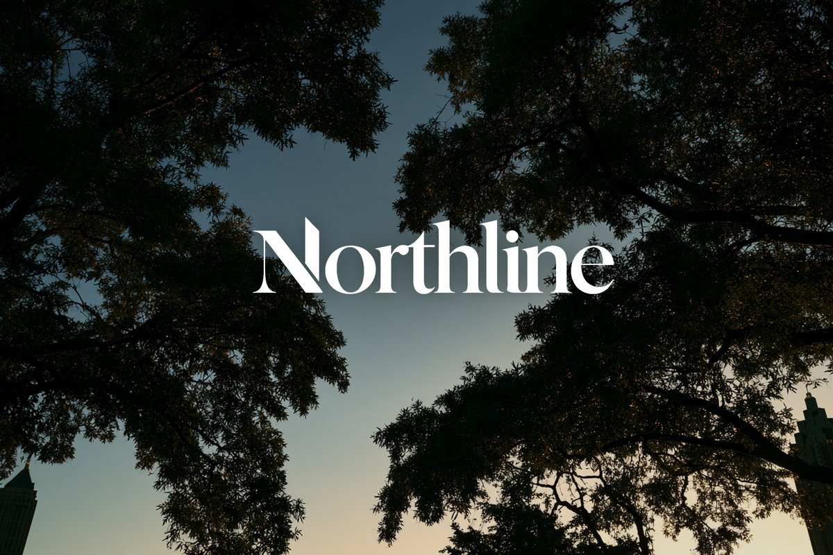 Northline logo over an oak canopy at dusk