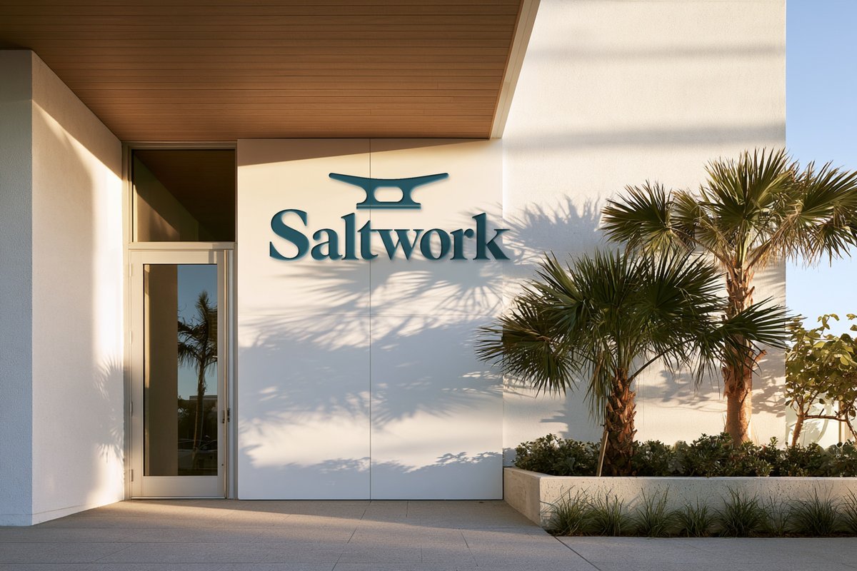 Saltwork logo on a white wall by palm trees