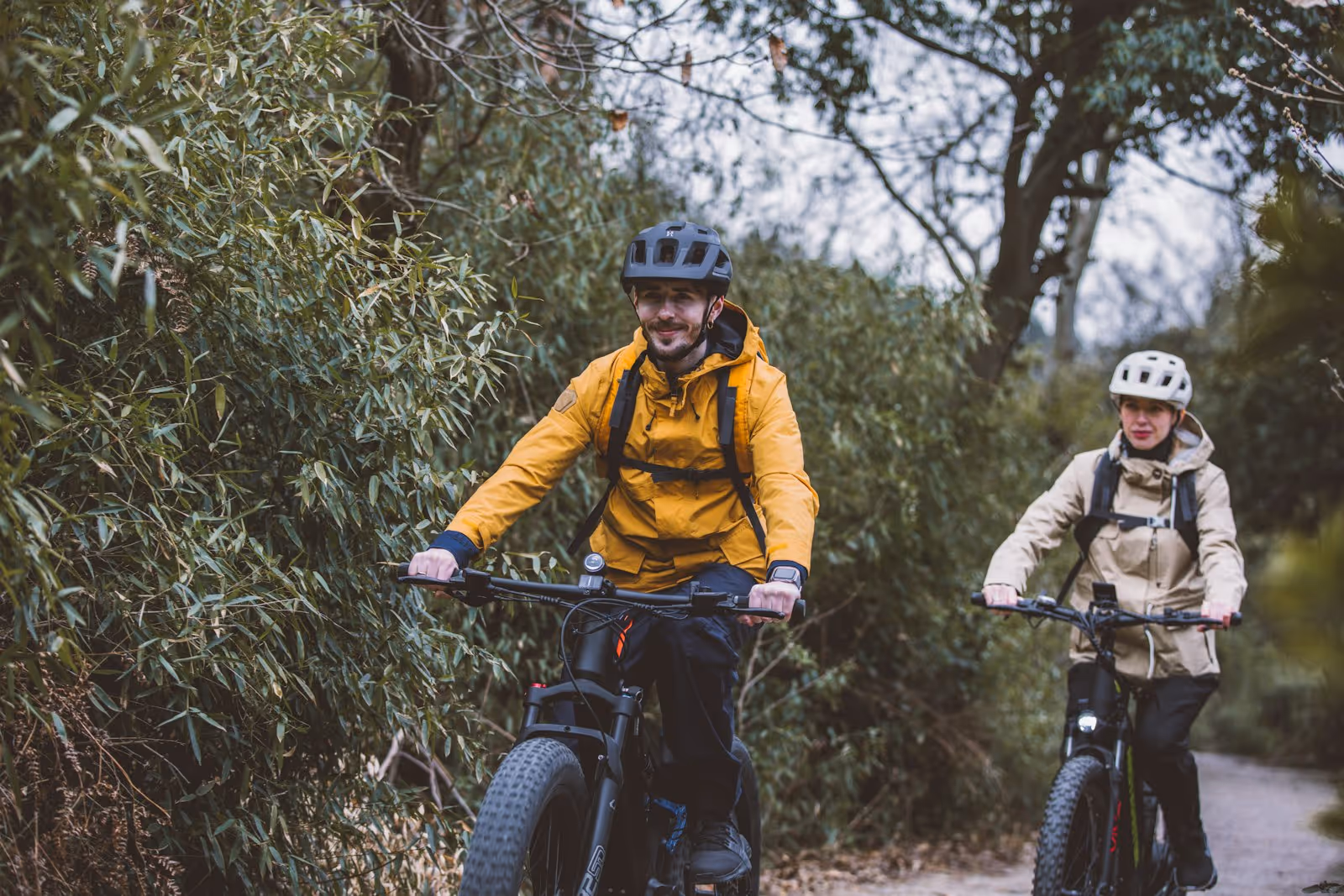 First-time rider smiling on a Class 1 e-bike on a sunny path near Bar Harbor, Maine