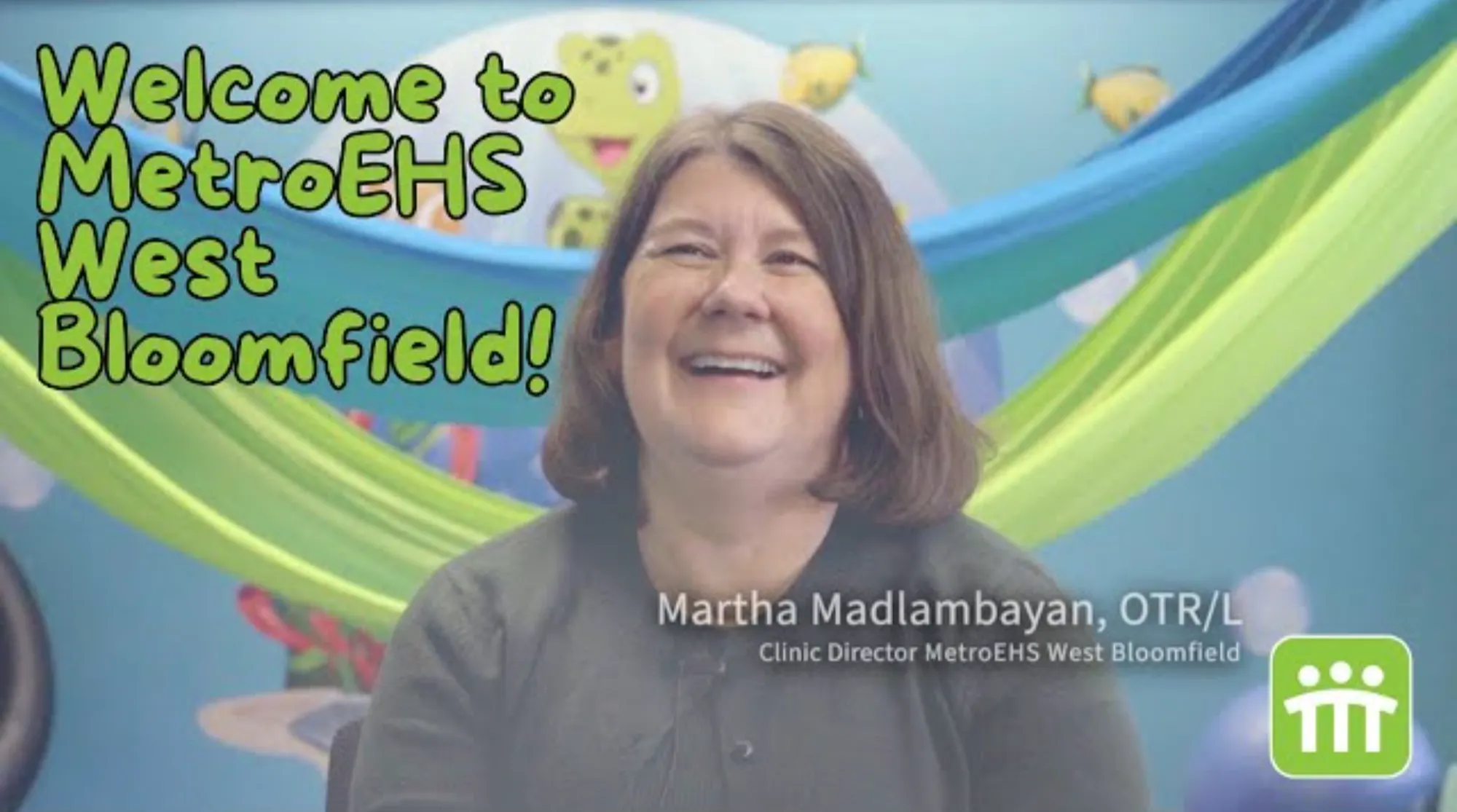 The clinic director sitting facing the camera talking about this MetroEHS clinic and what they do for children