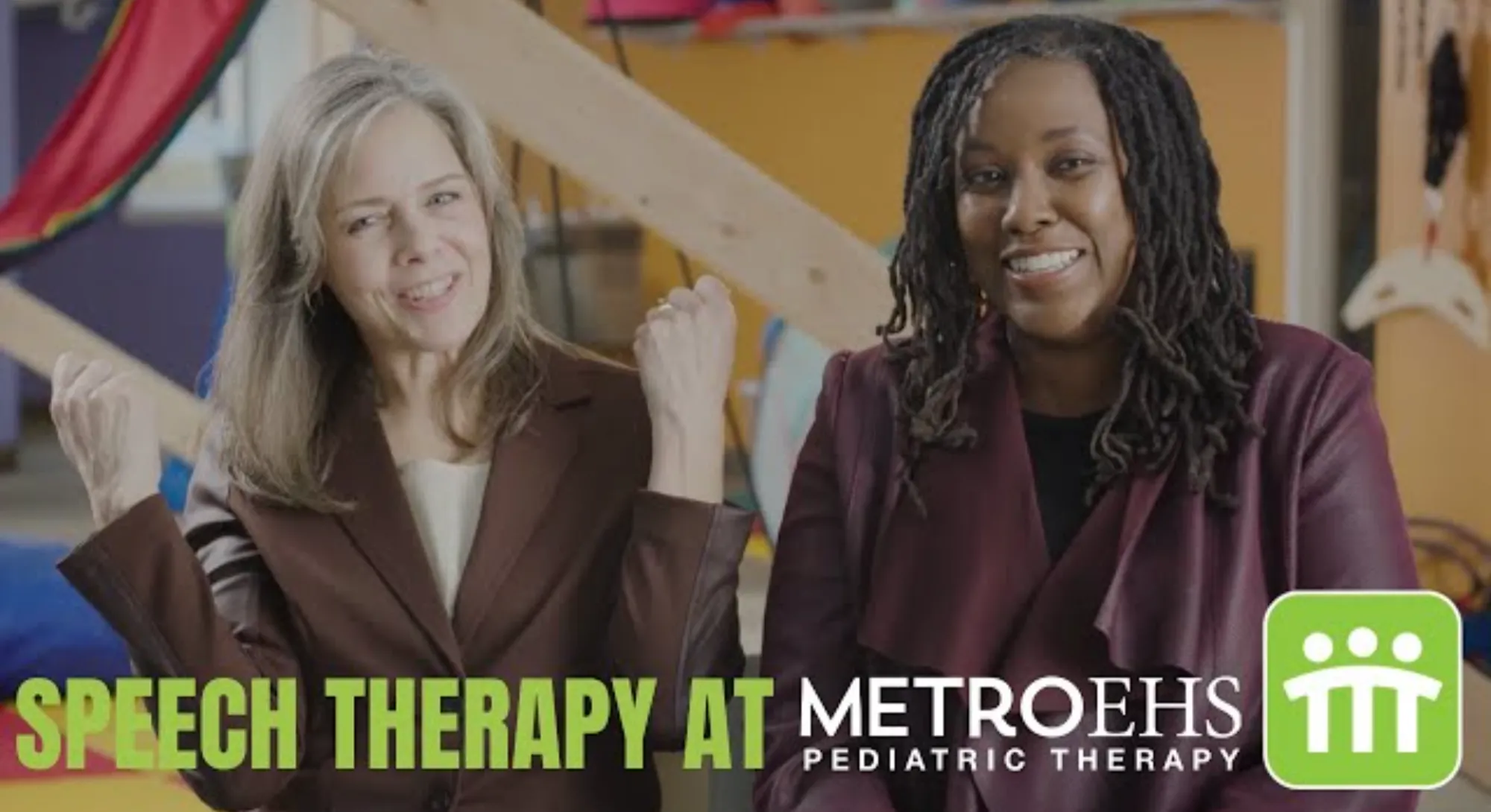 Two speech therapists sitting side by side smiling and talking about what they do for kids at MetroEHS