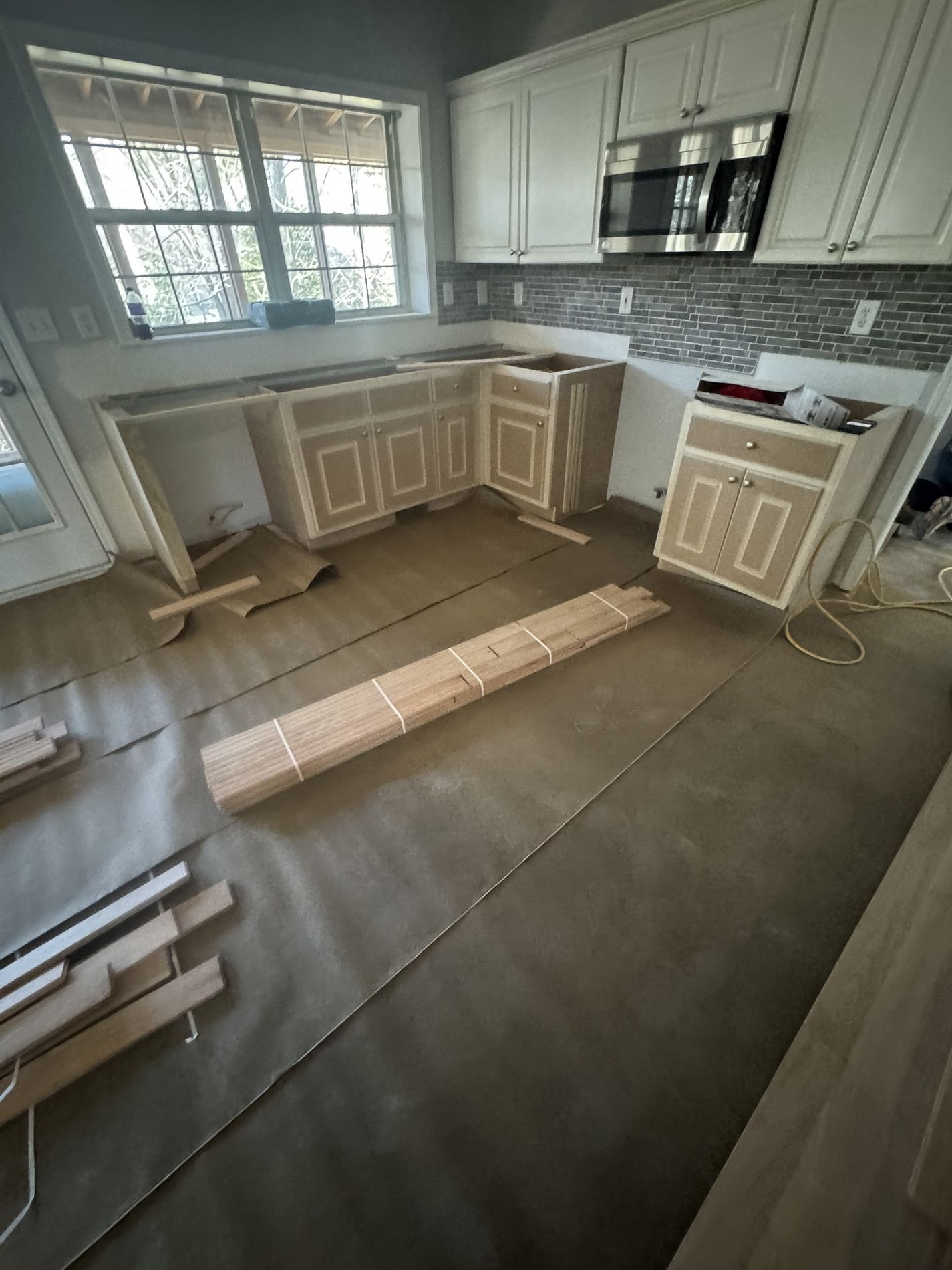 Home interior before restoration — mid-demo with unfinished floors and drywall in Cumming, GA