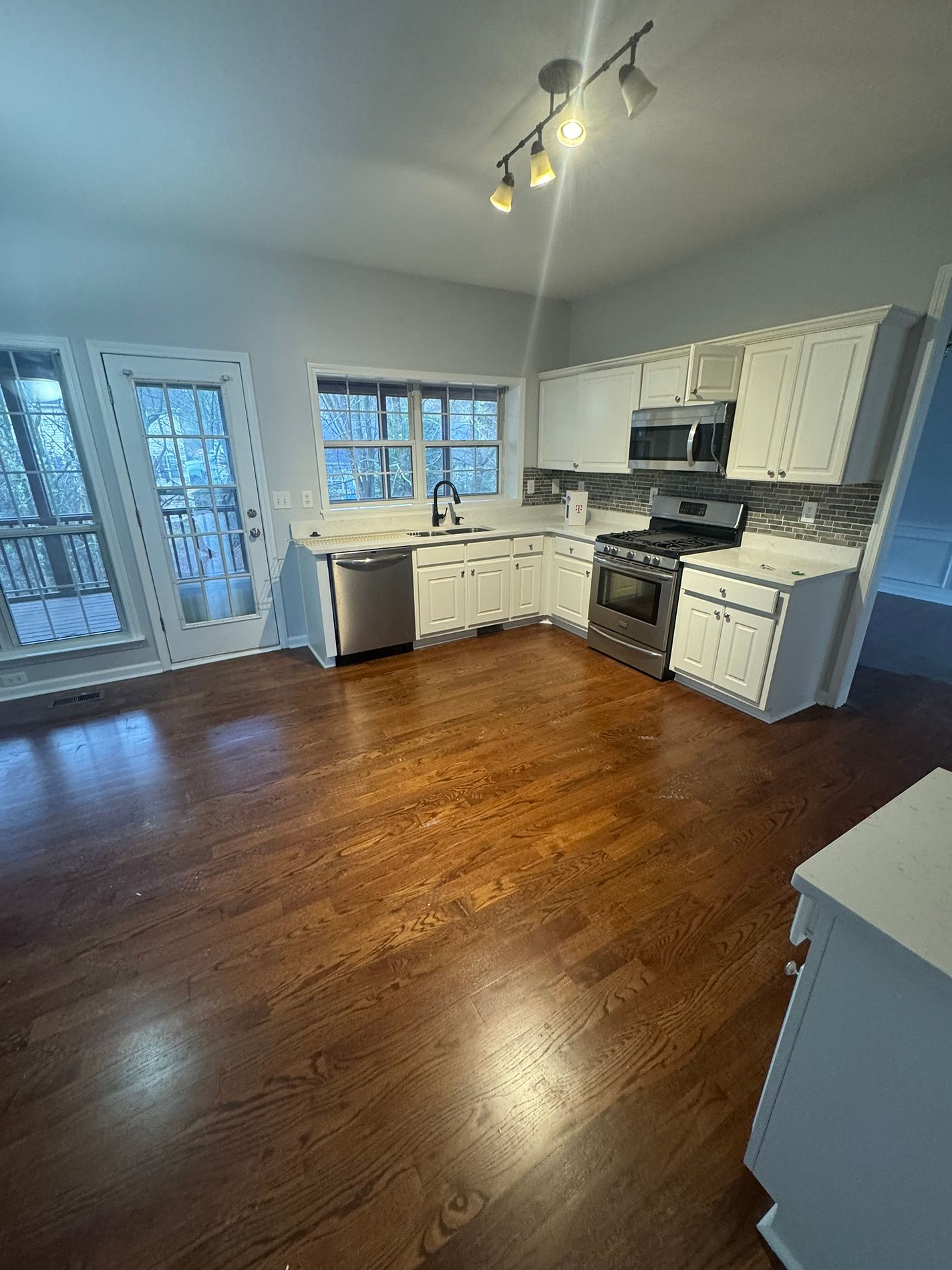 Completed kitchen renovation with quartz countertops and hardwood floors in Cumming, GA