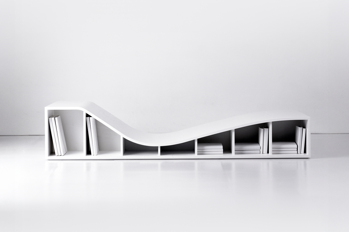LibriLounge chaise for Zero First, 2003. A single swooping line in bare wood, combining seating and book storage with no upholstery.