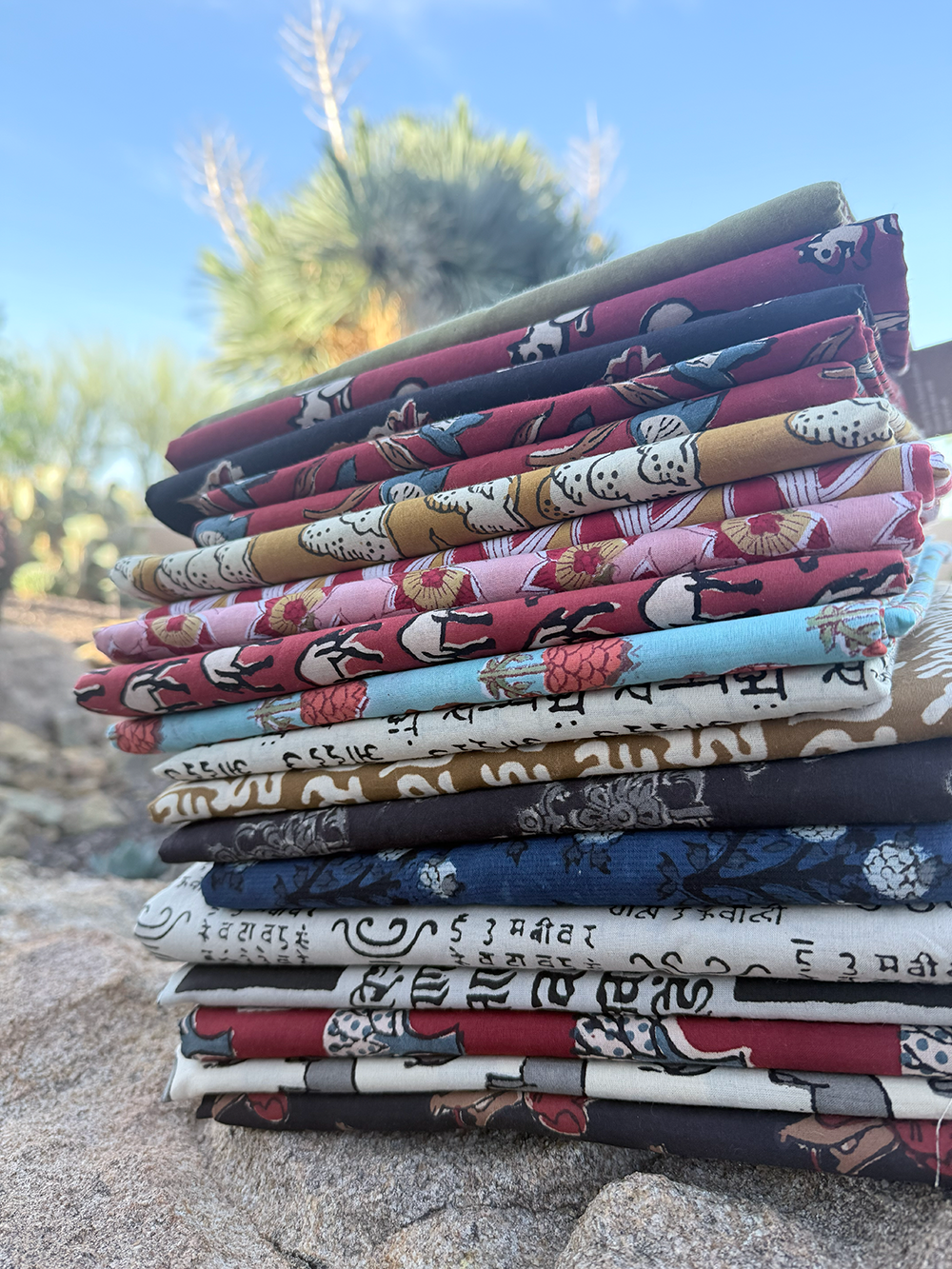 [background image] image of fabric rolls on shelves (for a tailors & alteration shop)