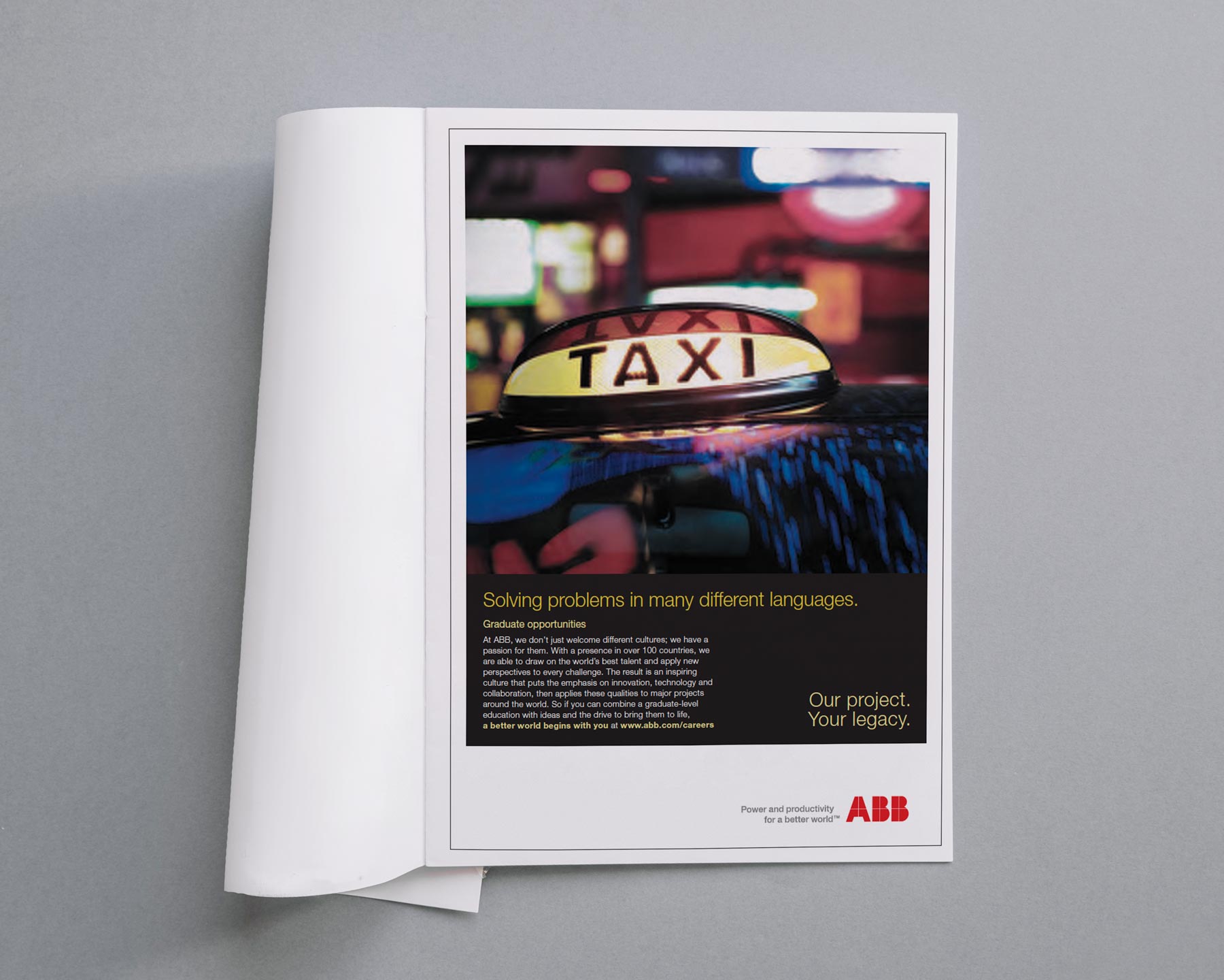 Magazine ad featuring a close-up photo of a taxi sign with blurred city lights in the background and text about graduate opportunities at ABB.