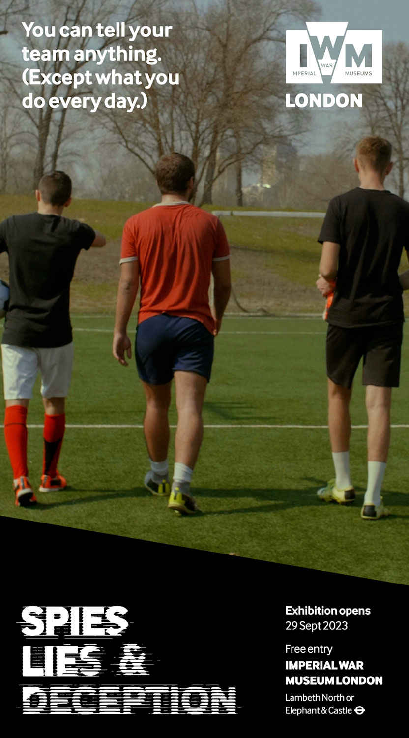 Three young men walking on a soccer field with text about the 'Spies, Lies & Deception' exhibition at Imperial War Museum London.