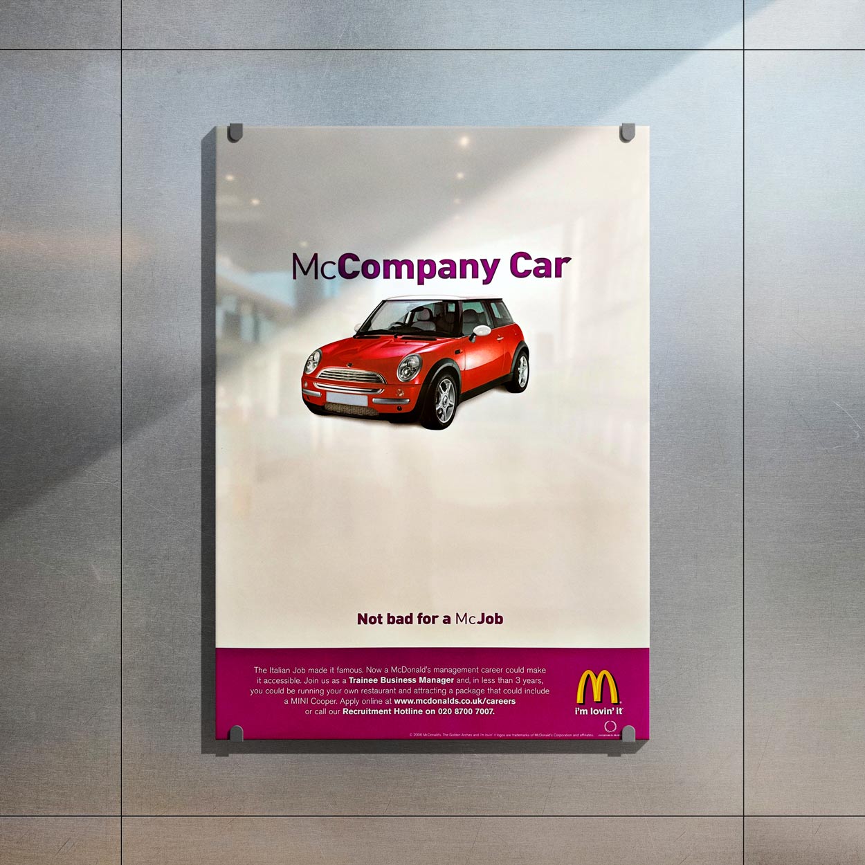 Recruitment poster featuring a red Mini Cooper with the text 'Company Car' and McDonald's logo promoting a management career as Trainee Business Manager.