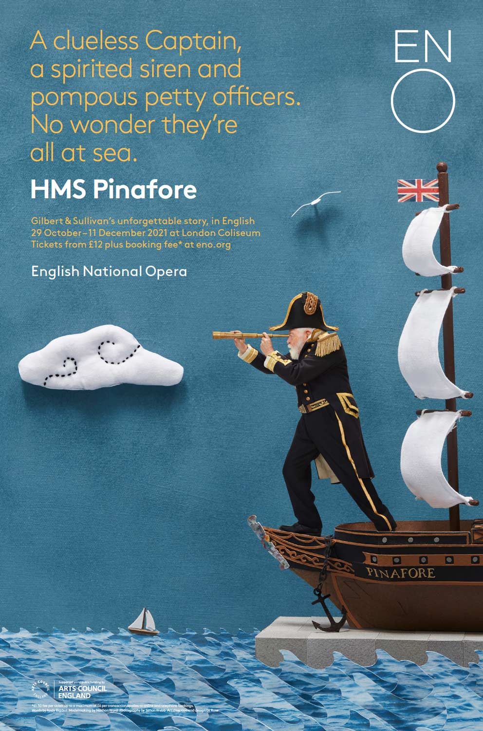 Illustration of a naval captain in uniform looking through a spyglass on a small ship named Pinafore floating on stylized paper waves with a Union Jack, a cloud, and a seagull on a blue background.