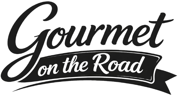 Black cursive text saying 'Gourmet' above a ribbon banner with the text 'on the Road'.