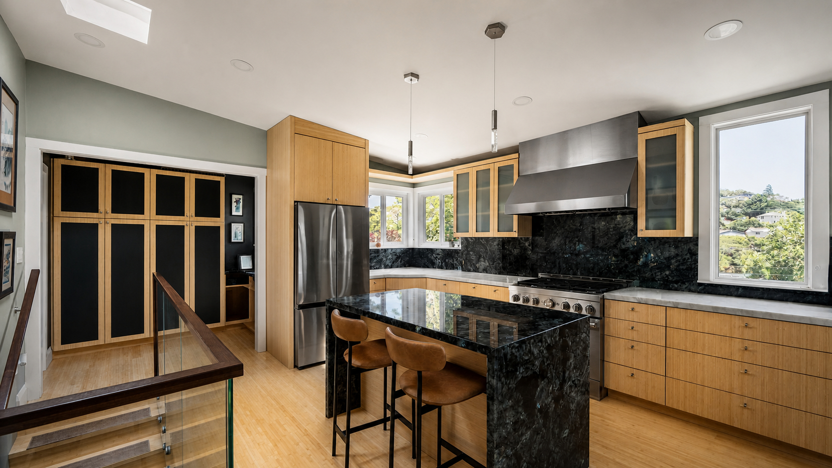 View of the kitchen with bamboo cabinetry, Lemurian Blue granite surfaces, and the pantry beyond.