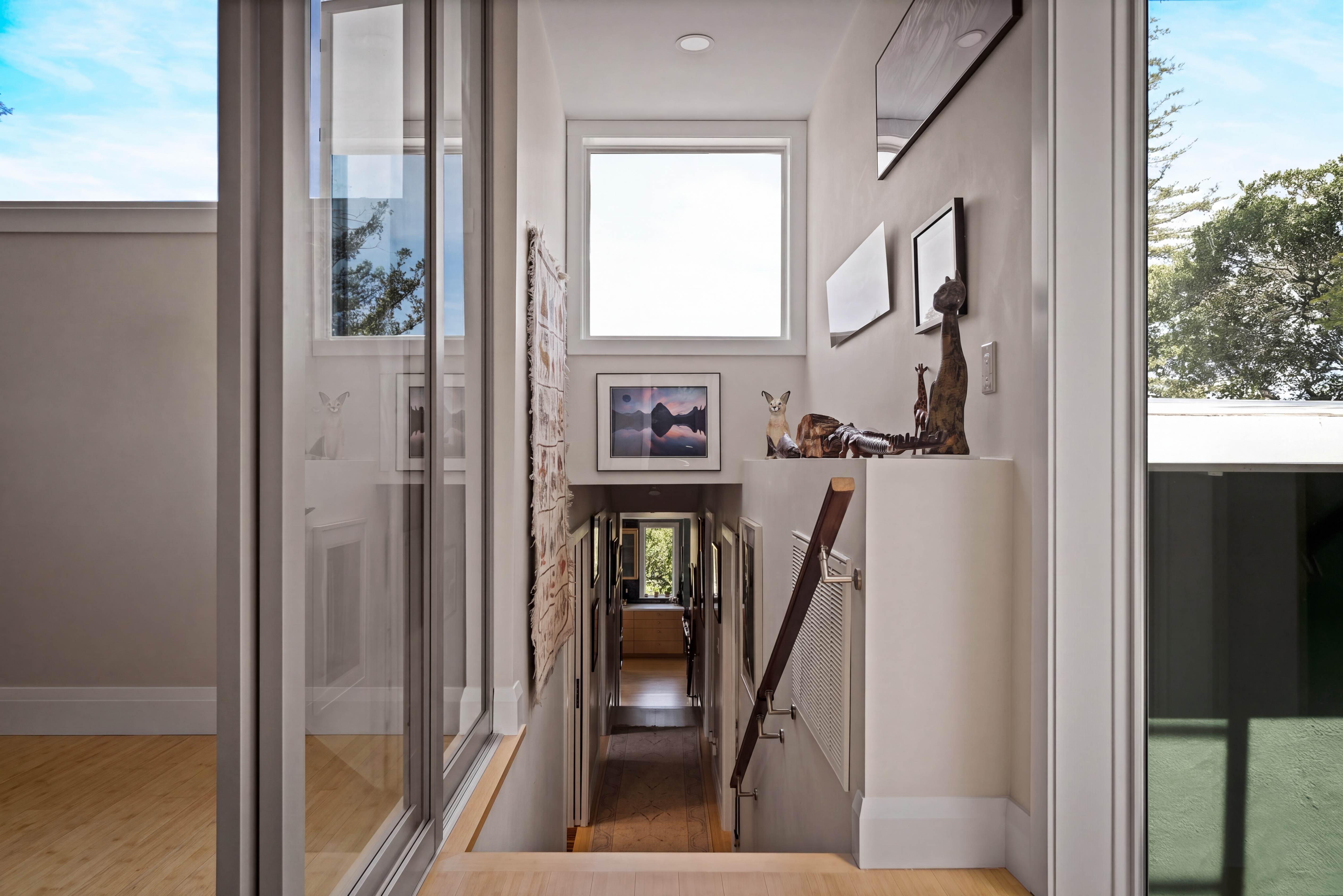 The stair hall turns a constrained vertical circulation space into a light filled transition between the upper addition and the original home.