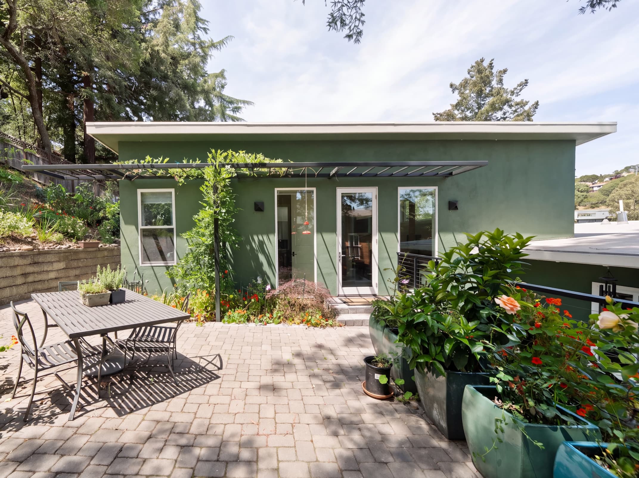 Looking down on the upper patio and addition and showing the syncopation of the roof forms.
