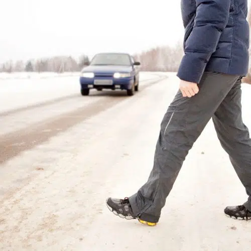 Pedestrian walking on road potentially about to be involved in pedestrian accident