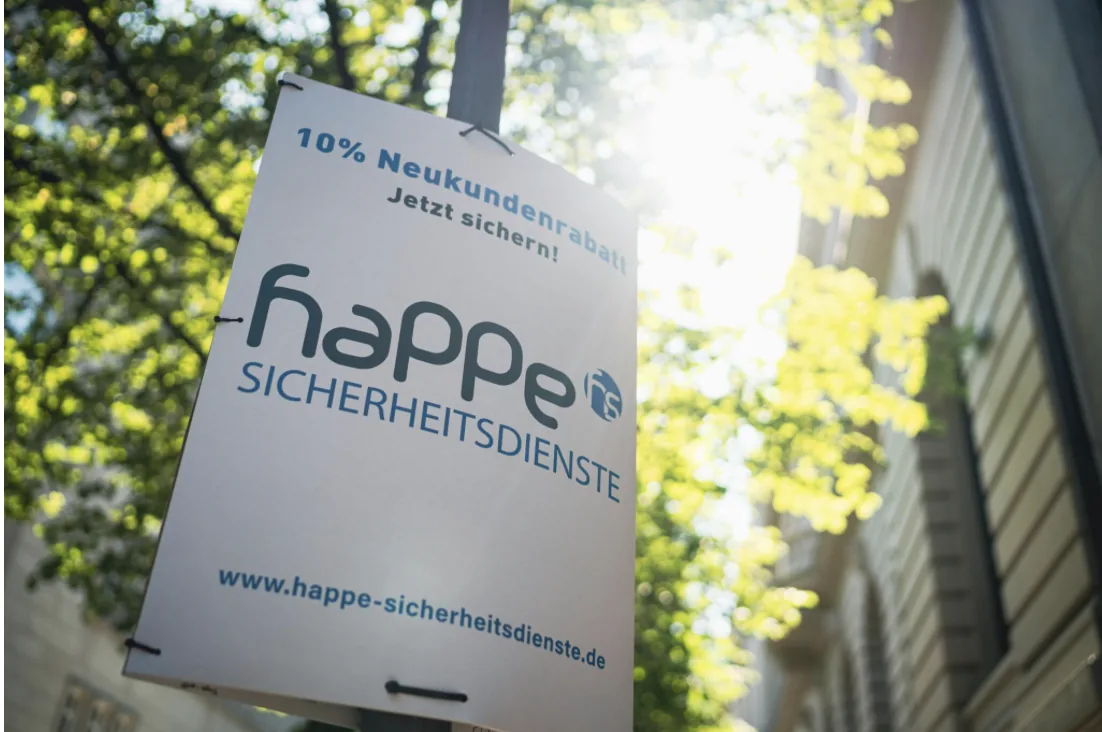 Pole Poster mit Werbebotschaft an einem Laternenmast