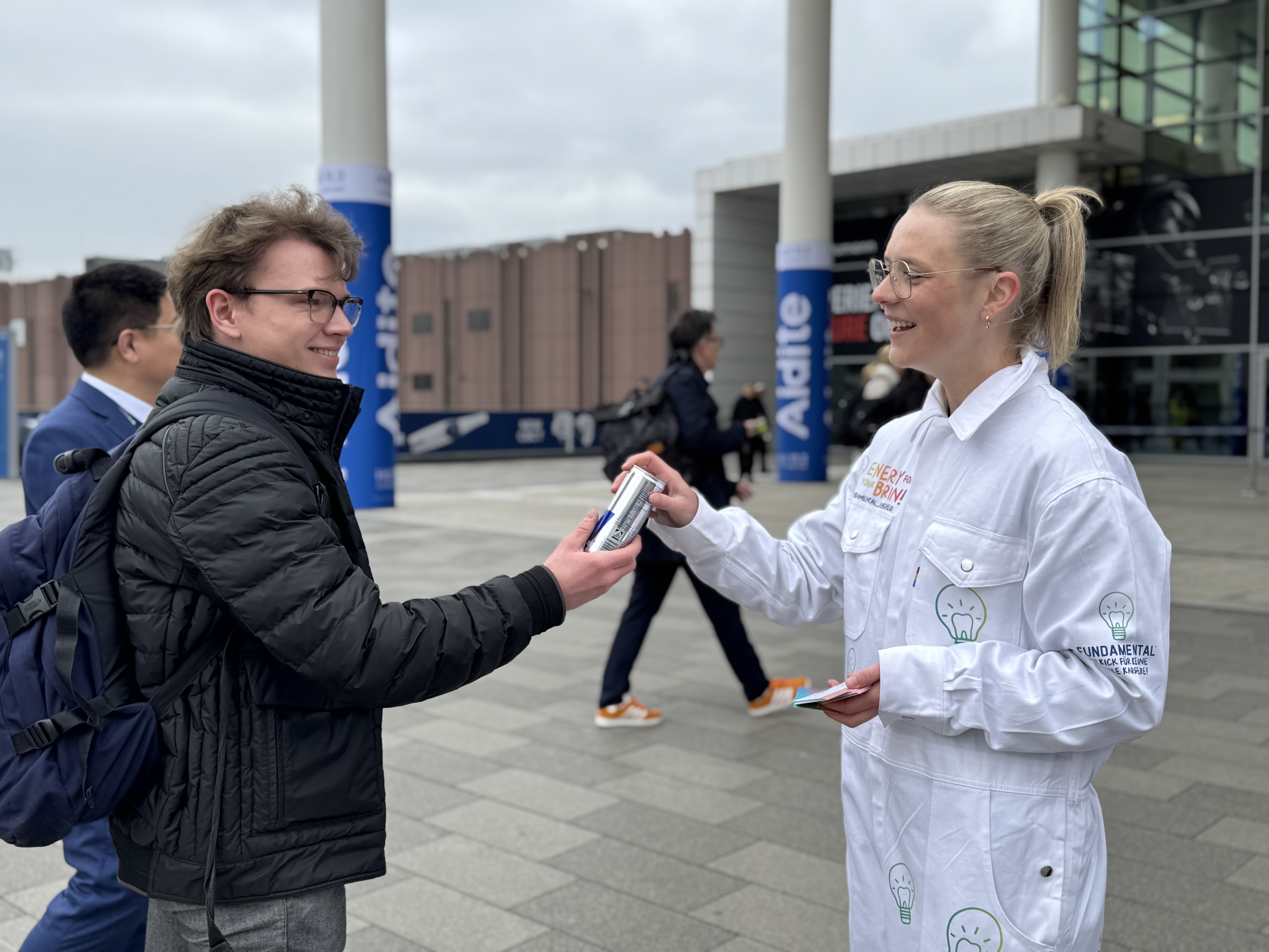 Promoterin gibt eine Person einen redbull