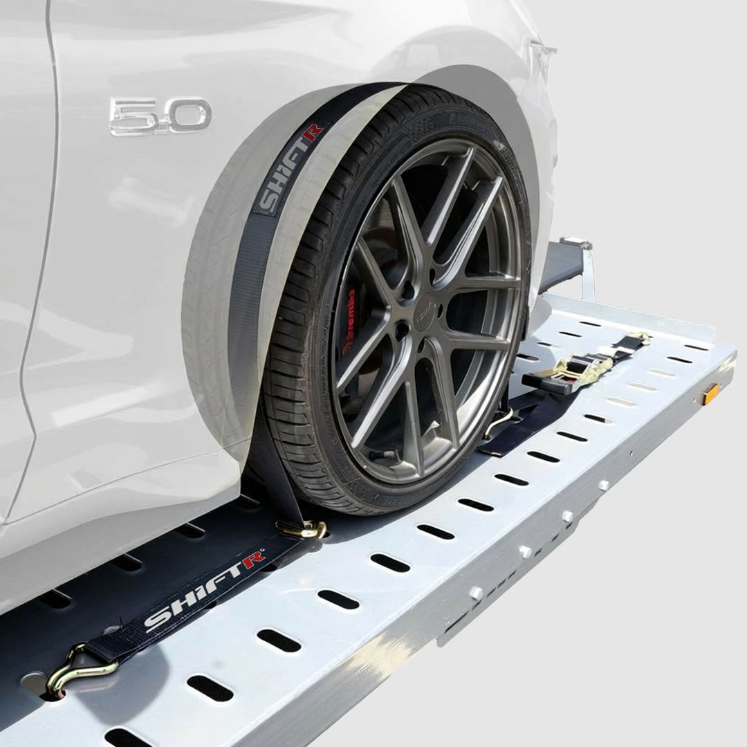 Over-tire SHIFTR tie-down straps for vehicle transport security